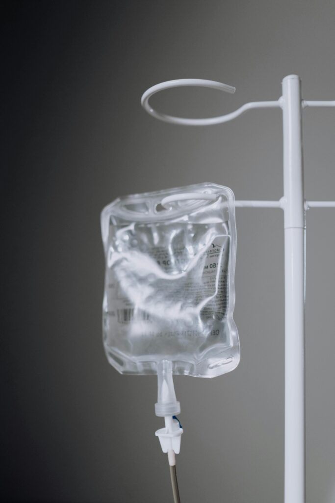 pexels-photo-6191530-6191530 A close-up view of an IV fluid bag hanging on a pole, ideal for healthcare concepts.
